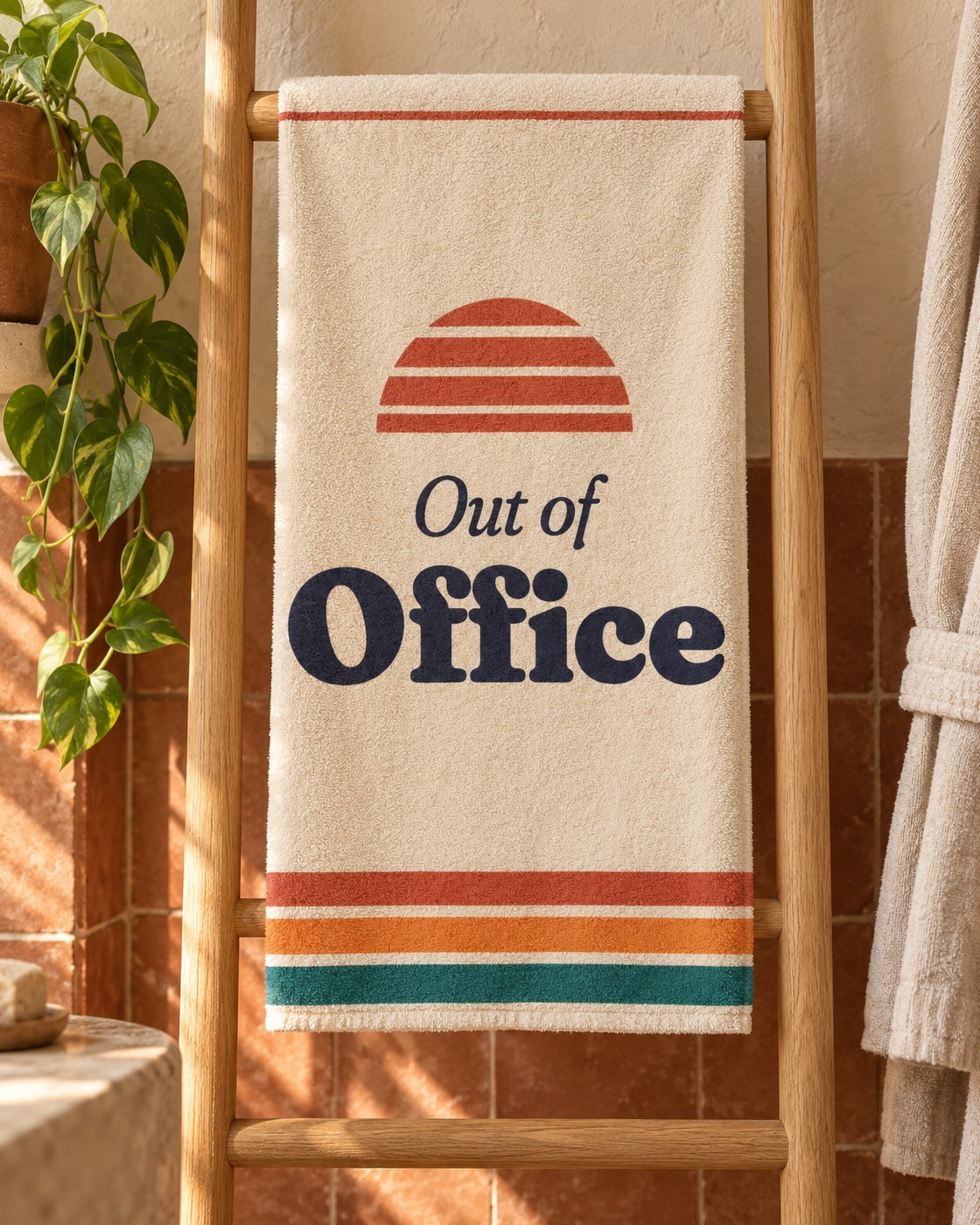 Out of Office sweat towel hanging on a wooden towel ladder