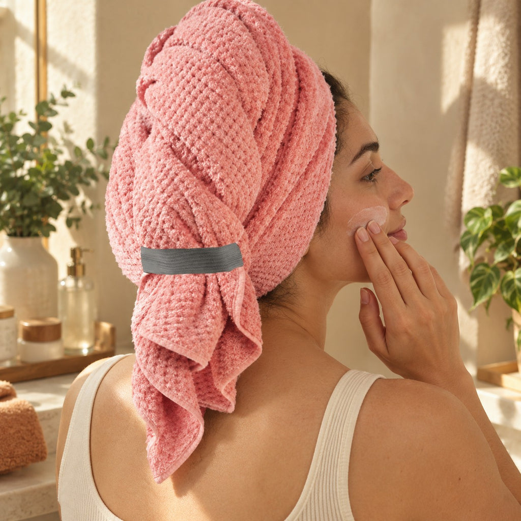 Coral hair towel wrap held by its elastic loop during skincare