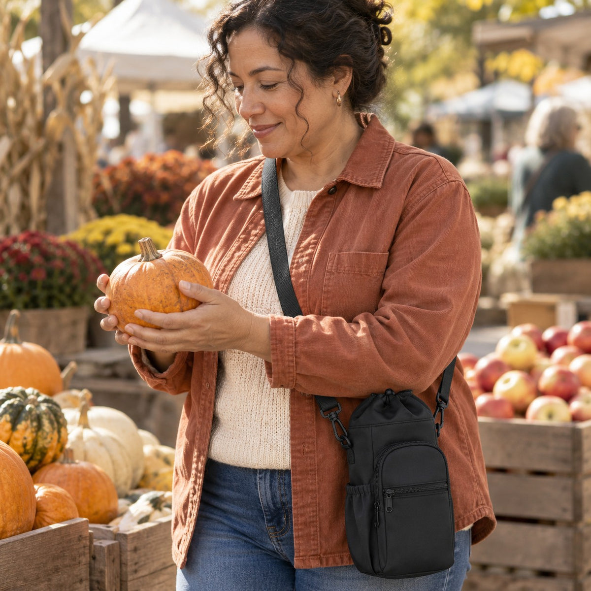 Black tumbler sling worn crossbody at a farmers market
